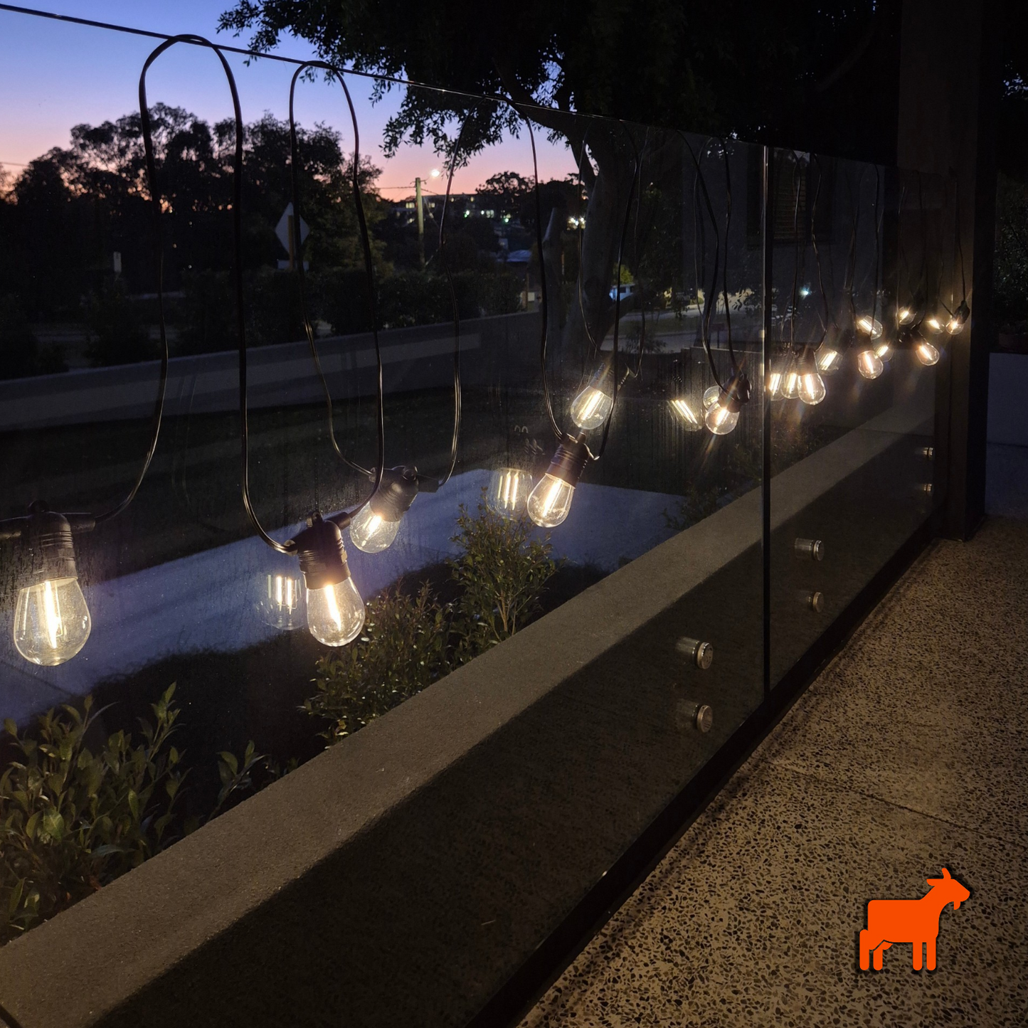 Solar festoon lights glowing at night creating warm ambient backyard garden lighting