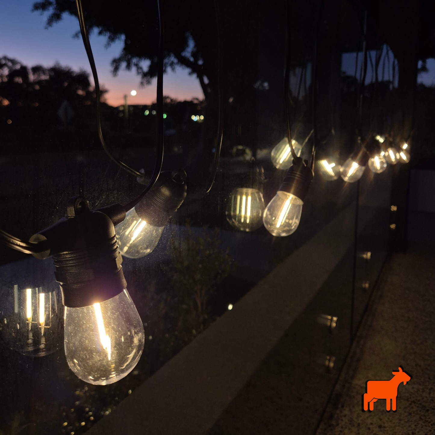 Solar garden festoon lights installed across outdoor patio and pergola during daytime